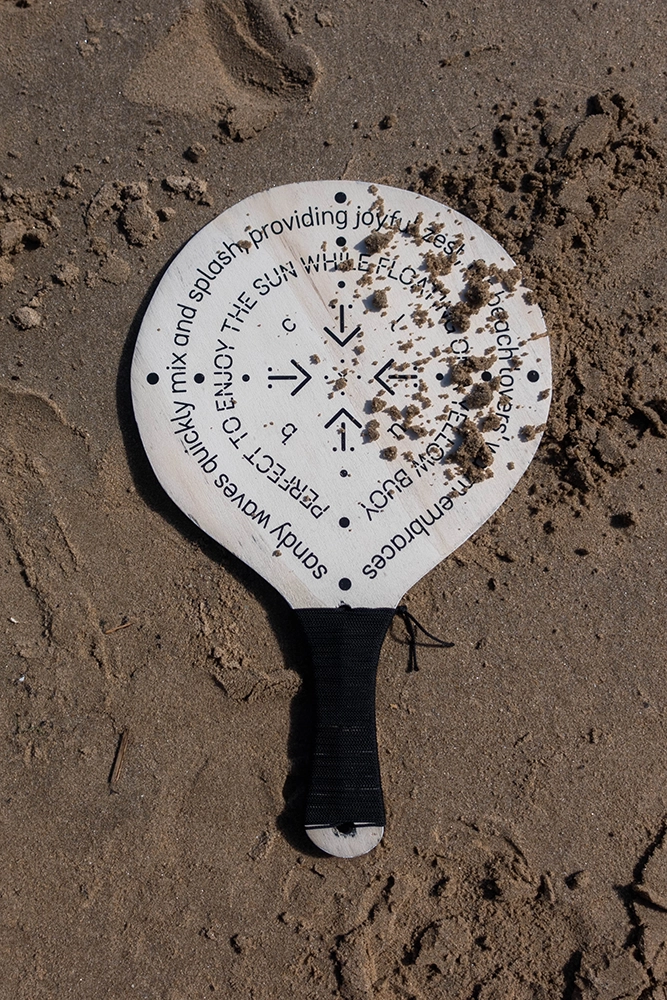 Beach Club racket in the sand